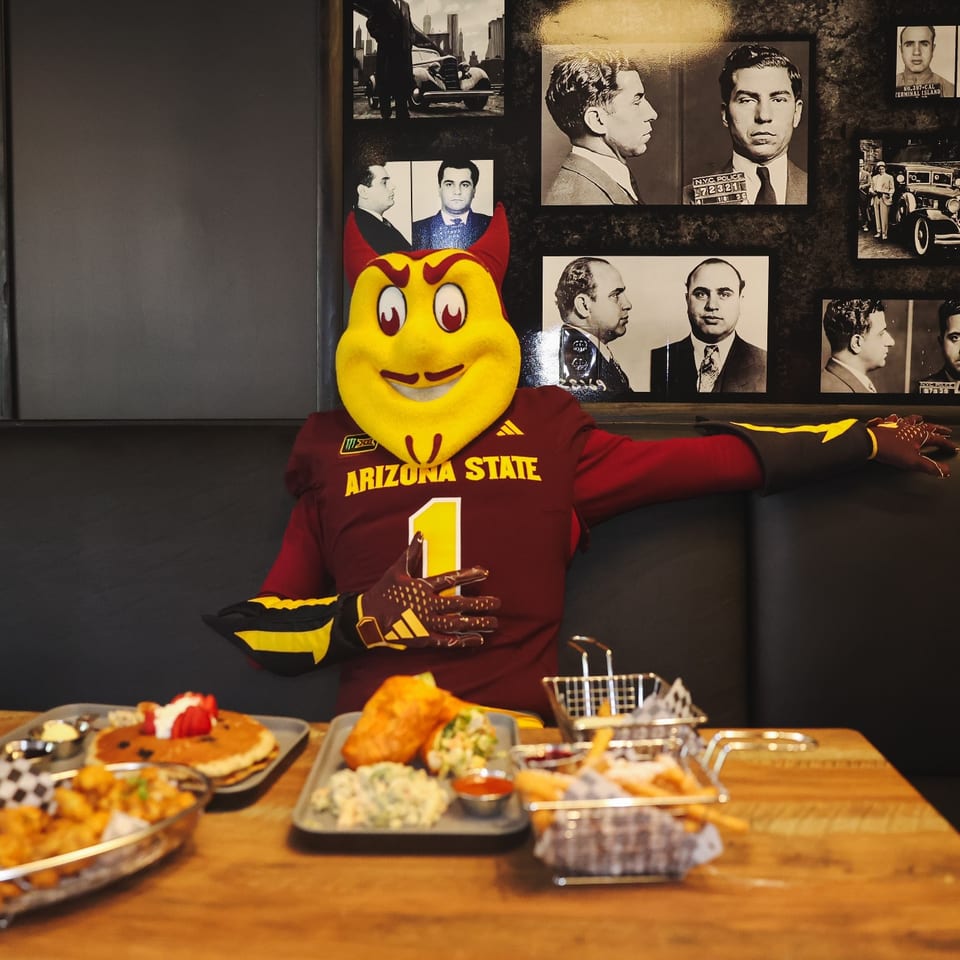 Arizona State mascot enjoying a booth at the Tempe location